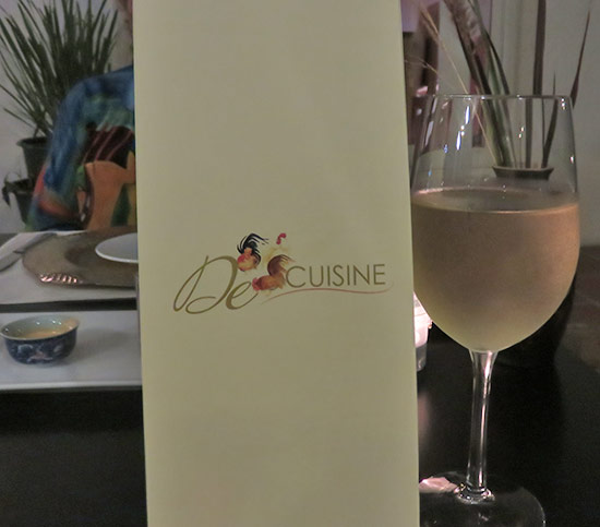 menu and a glass of wine at de cuisine