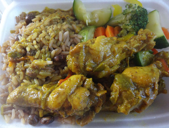 curry chicken wings with rice and peas and vegetables