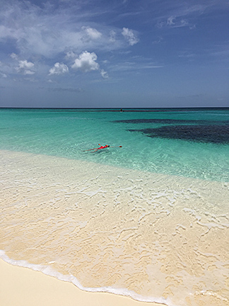 lady floating and soaking up the sun on shoal bay