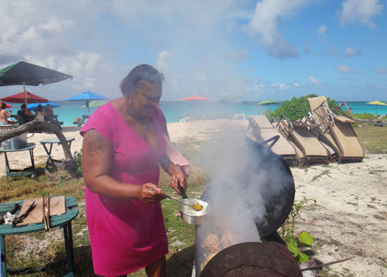 gwen buttering bbq lobster at her beach bar