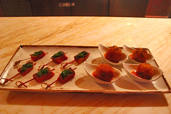 rose night hors d'oeuvres of rice and peas arancini and prime aged ribeye sate