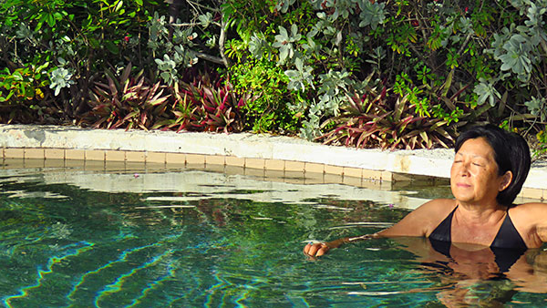 mom taking in the sun at bird of paradise private pool