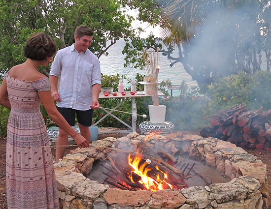 roasting marshmallows on an open fire at malliouhana