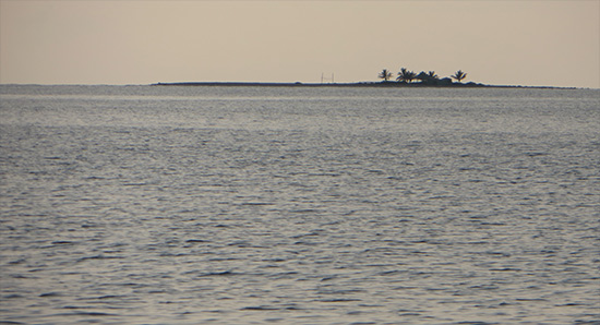 sandy island at sunset