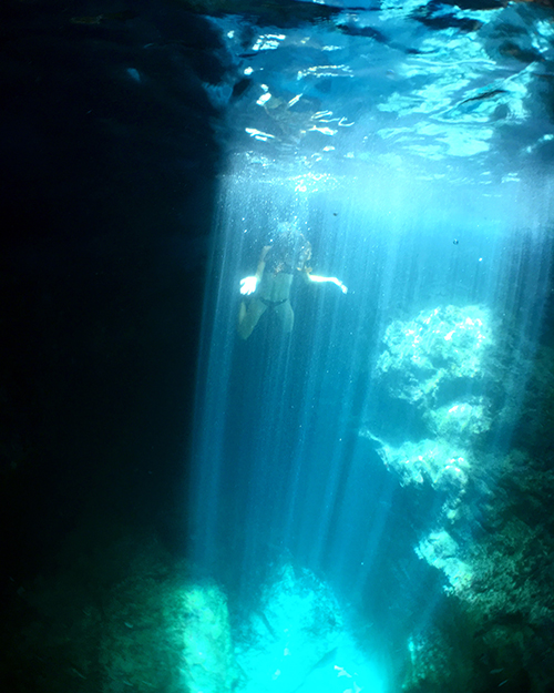 sunrays inside scrub island sea cave