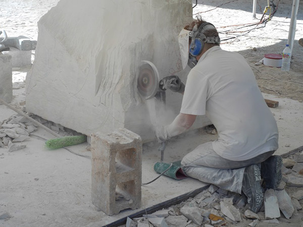 grinding stone into sculpture in anguilla