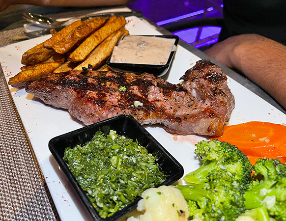 Ribeye Steak with Peppercorn & Chimichurri at Movida Rotisserie & Grill
