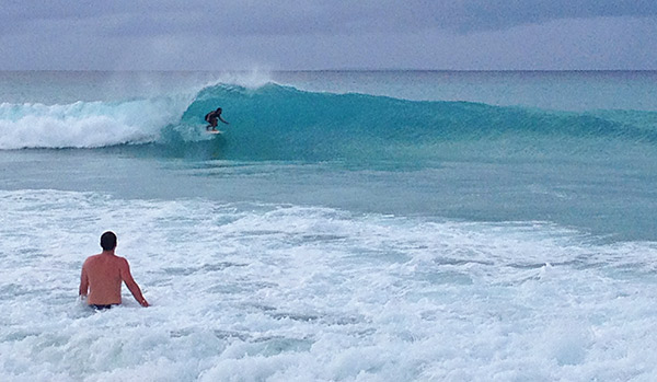 surfing on meads bay anguilla in front of bamboo bar and grill