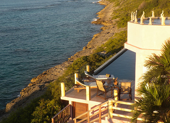 suspended jacuzzi with pool in background at villa hibernia