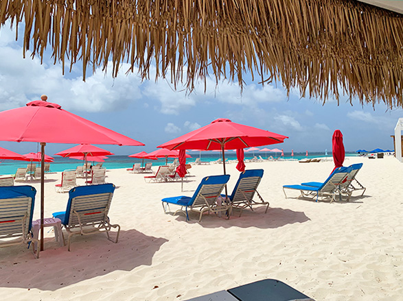 view from uncle ernies beach bar of umbrellas and the water of shoal bay, anguilla