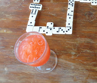 rum punch while playing dominoes on sandy ground
