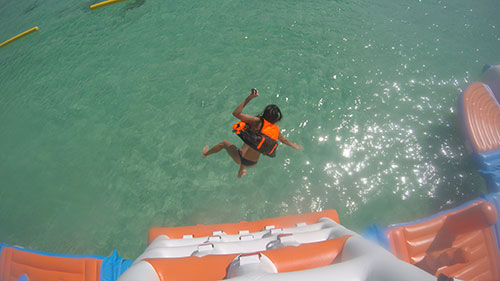 jumping into the water from the aqua park
