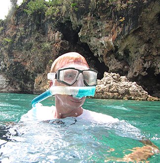 dad with snorkel mask in little bay