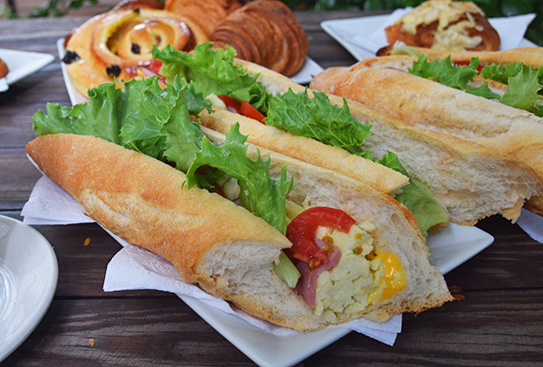 egg ham and cheese sandwich with lettuce and tomato