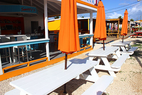 exterior dining space at sharpys including umbrellas and picnic tables