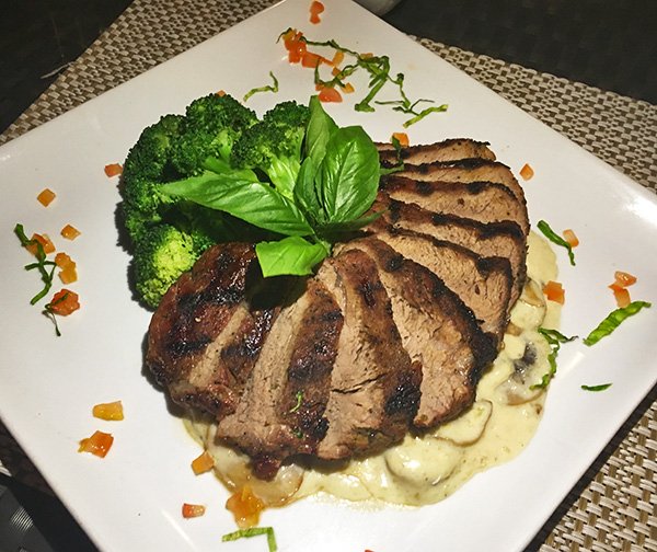 grilled striploin steak with creamy mushroom sauce and broccoli
