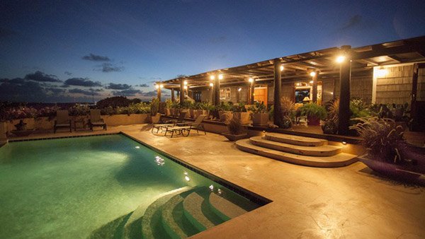 wesley house with pool in foreground by night