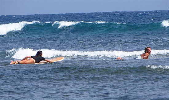 paddling out to surf in jobos puerto rico with rincon surf school