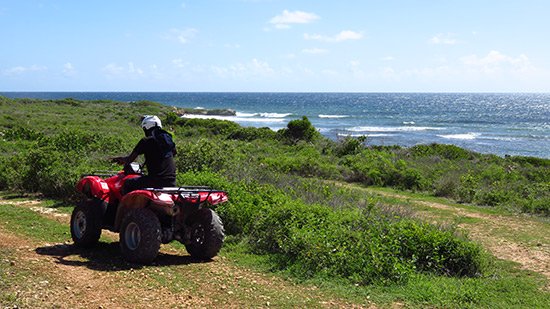 kirmani on freedom rentals atv with caribbean sea in the background