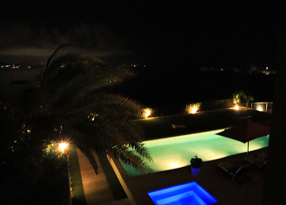 Pool lights at night with view of Saint Martin