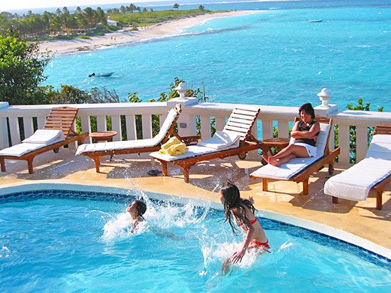 jumping into tortue villa pool in anguilla overlooking shoal bay