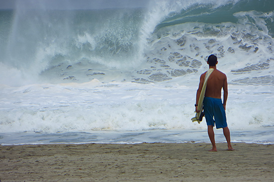 surfer watching the big waves at puerto escondido's main beach, zicatela