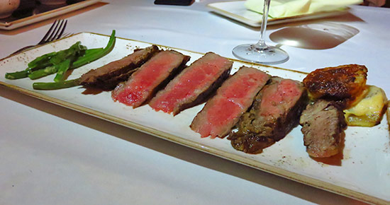 signature cut of tomahawk steak plated at malliouhana
