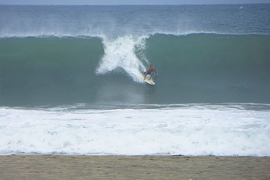 surfer watching the big waves at puerto escondido's main beach, zicatela