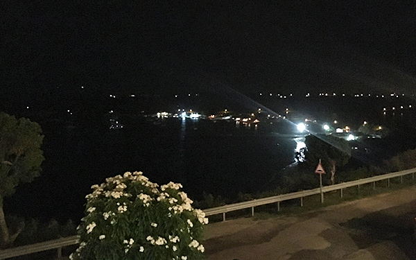 view of sandy ground from flavors restaurant at night