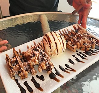 Waffle bites with vanilla icecream and chocolate syrup