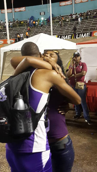 zharnel hughes hugs his mother after running in the 2014 ISSA championships in Jamaica
